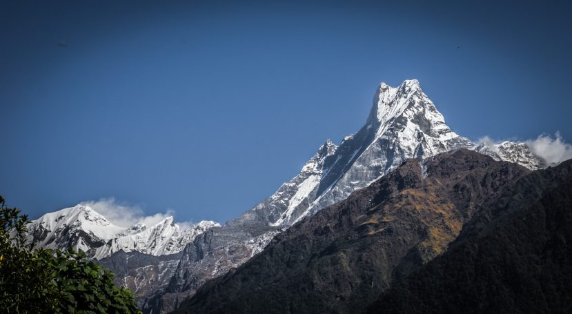 Schneebedeckter Gipfel eines Berges vor klarem, blauem Himmel.